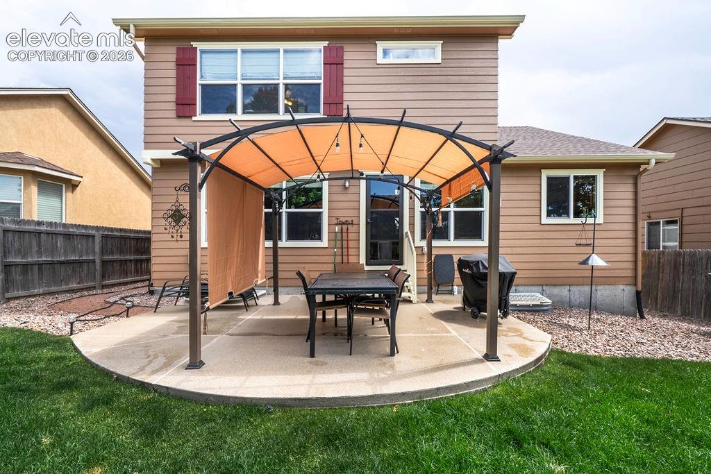 Image 9 of 44: Backyard patio with an awesome covered pergola, great for outdoor dining an