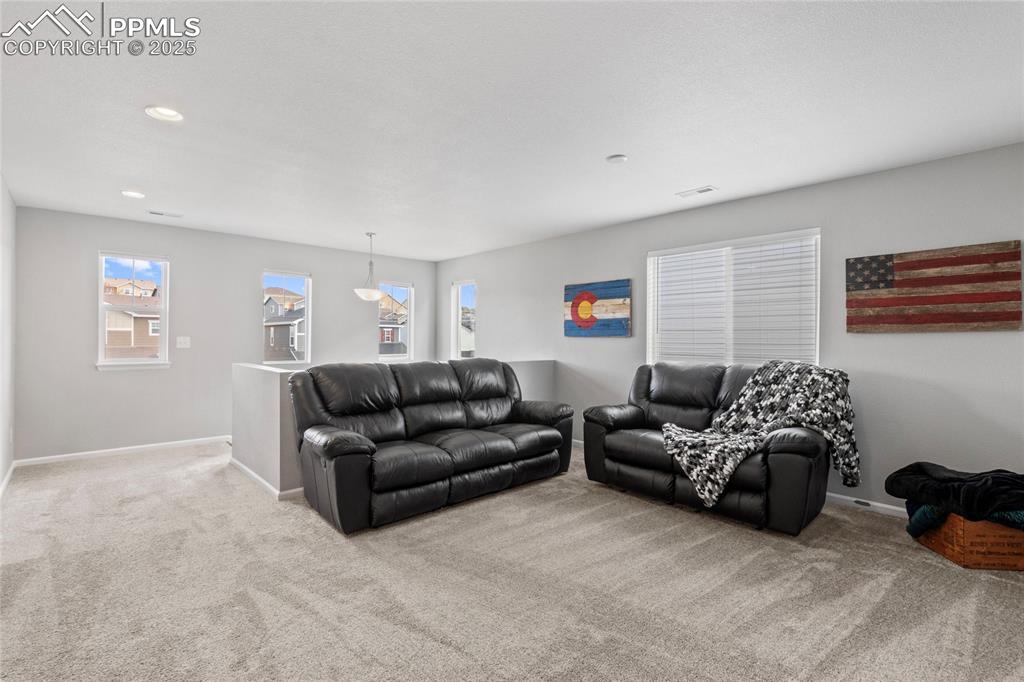 Image 18 of 44: Carpeted living room featuring baseboards