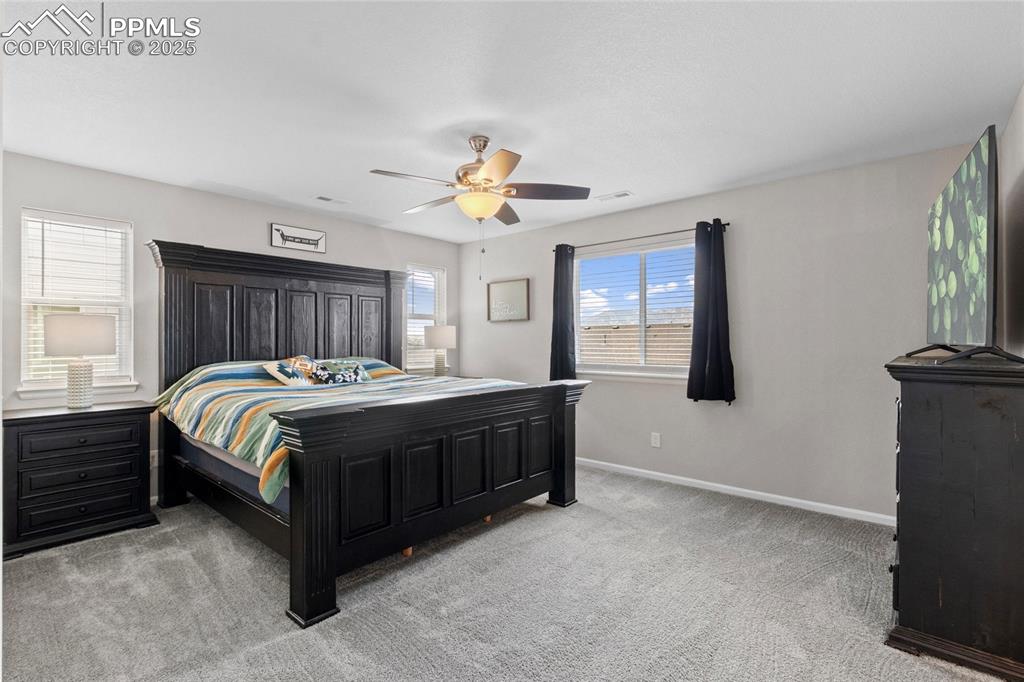 Image 19 of 44: Bedroom featuring light colored carpet and ceiling fan