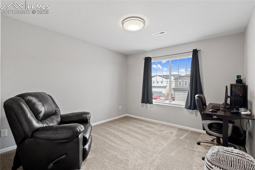 Image 23 of 44: Office space with baseboards and light colored carpet