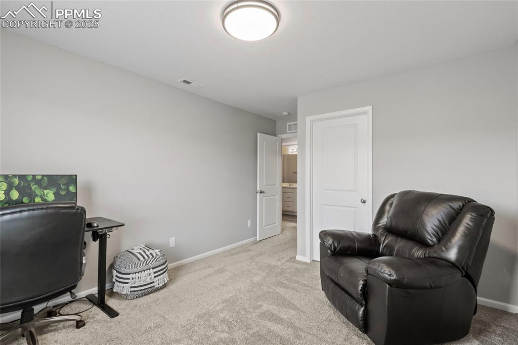 Image 24 of 44: Carpeted home office featuring baseboards