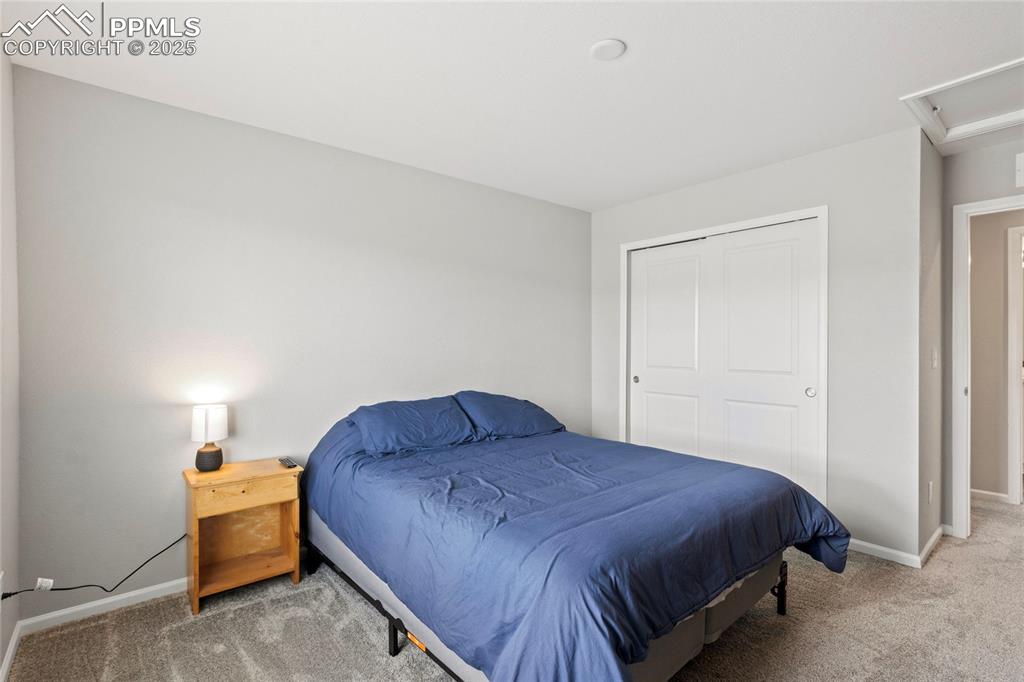 Image 26 of 44: Bedroom with carpet, a closet, and attic access