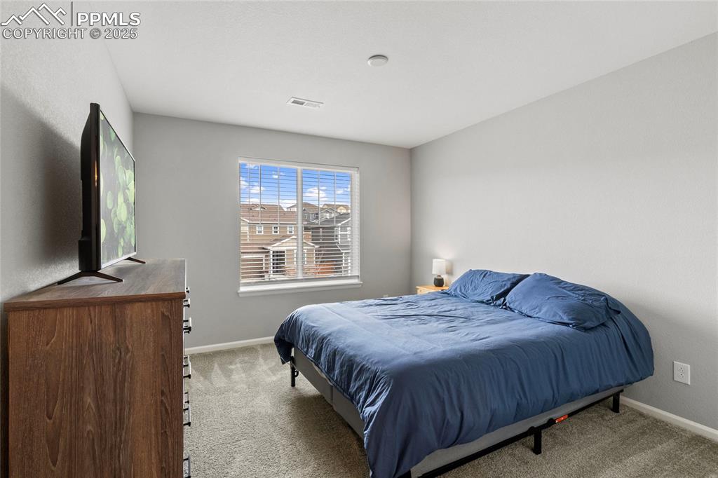 Image 27 of 44: Carpeted bedroom featuring baseboards