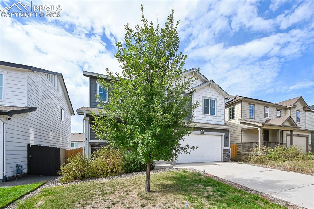 Image 3 of 44: View of front of home featuring concrete driveway and a garage