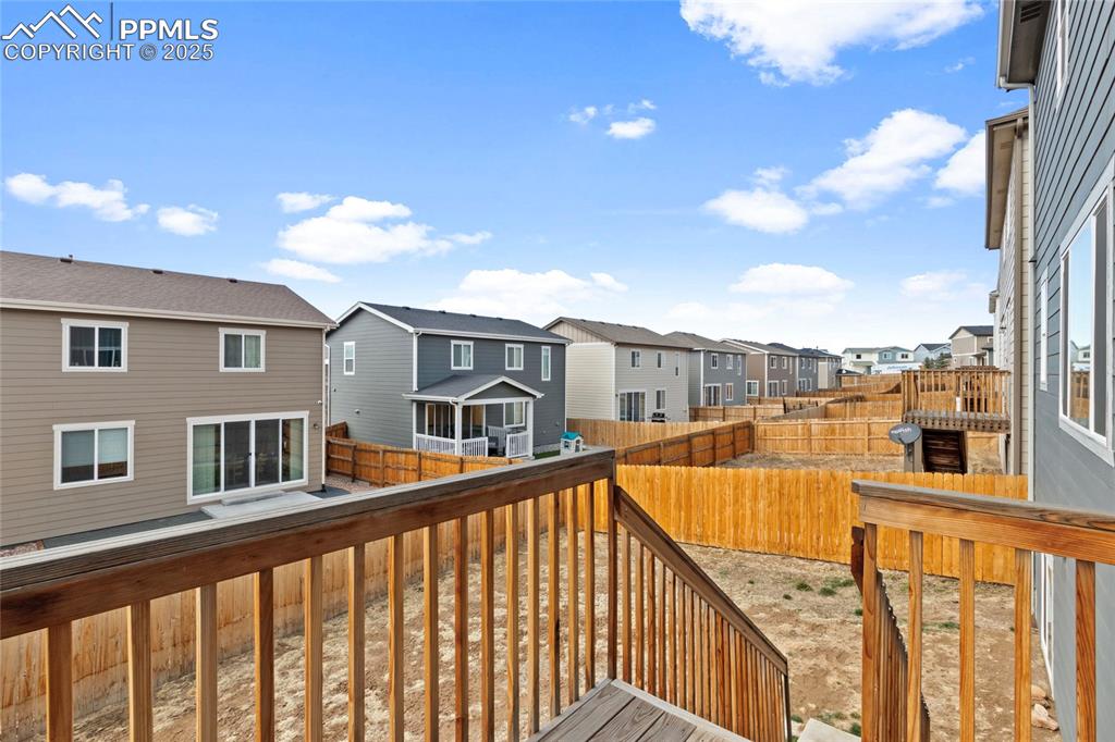 Image 32 of 44: Wooden deck with a fenced backyard and a residential view