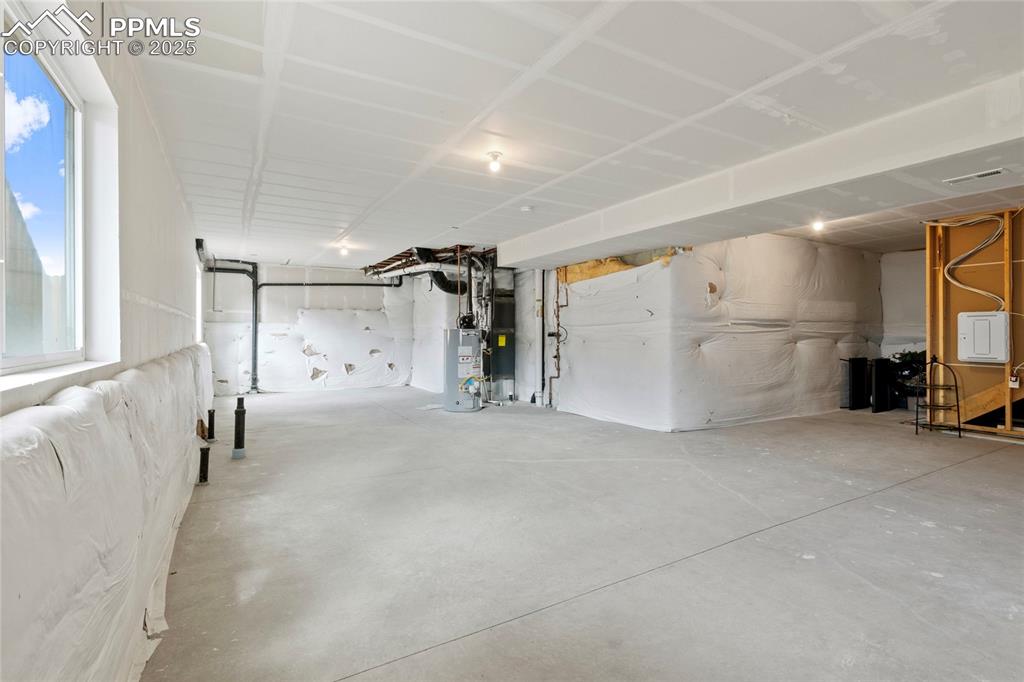 Image 44 of 44: Garage featuring gas water heater