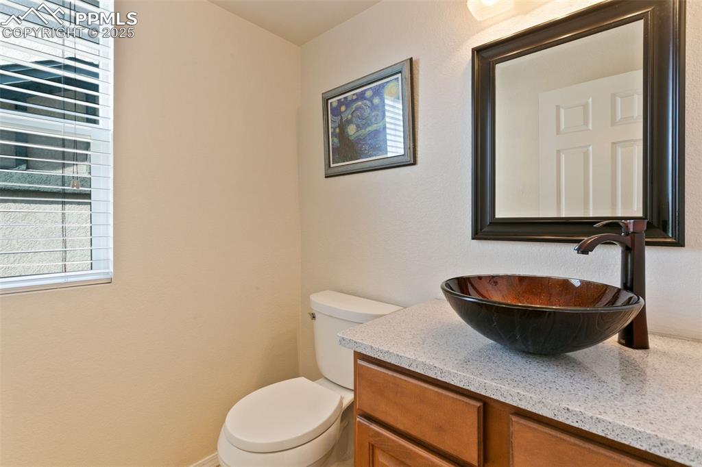 Image 11 of 29: Main level Bathroom with vanity off of entry way