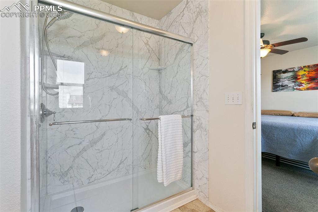 Image 17 of 29: Main bathroom featuring a newly updated marble finish shower, and tile floo