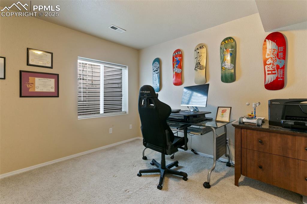 Image 24 of 29: Basement bedroom or office featuring light colored carpet and large closet
