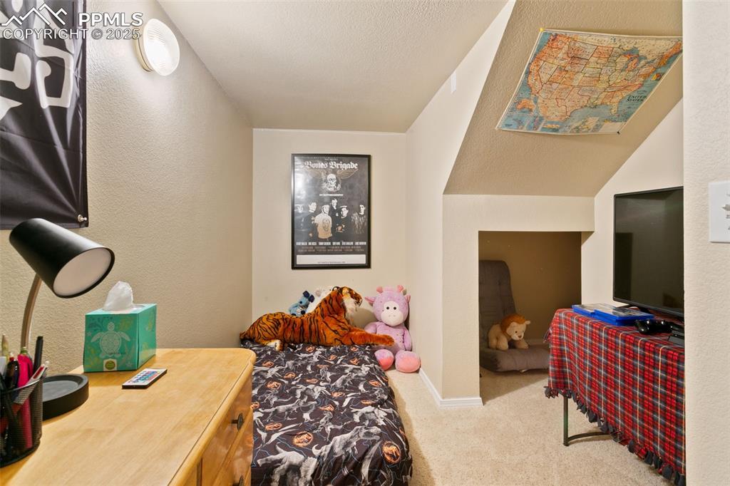Image 27 of 29: Secret room featuring a hidden nook under the stairs