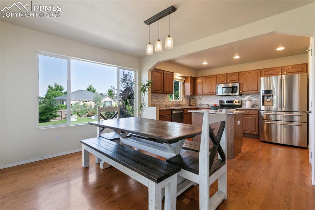 Image 4 of 29: Dining room with lots of natural light, wood finished floors, recessed ligh