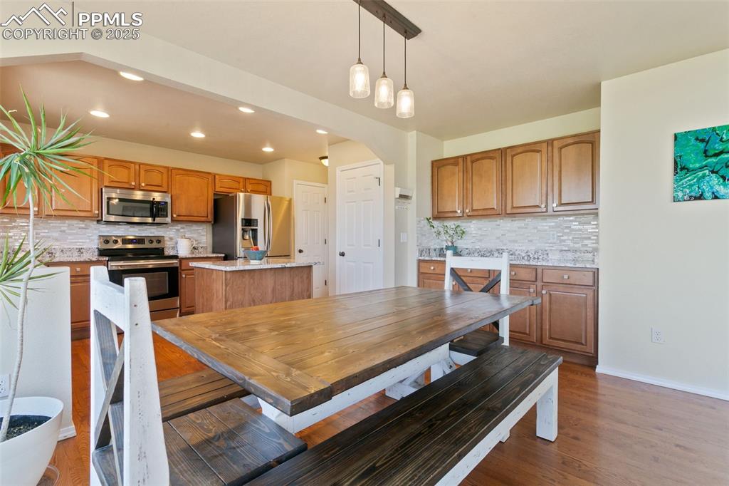 Image 5 of 29: Dining area with built-in bar nook and cabinets