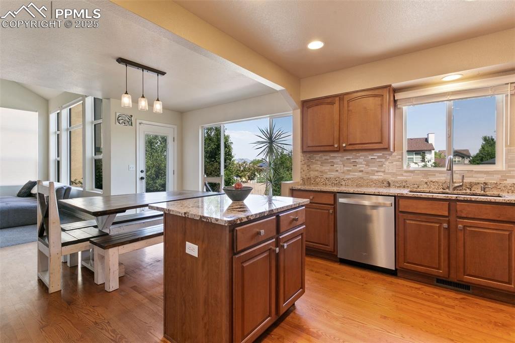 Image 7 of 29: Kitchen view into dining room with walkout to back yard and patio