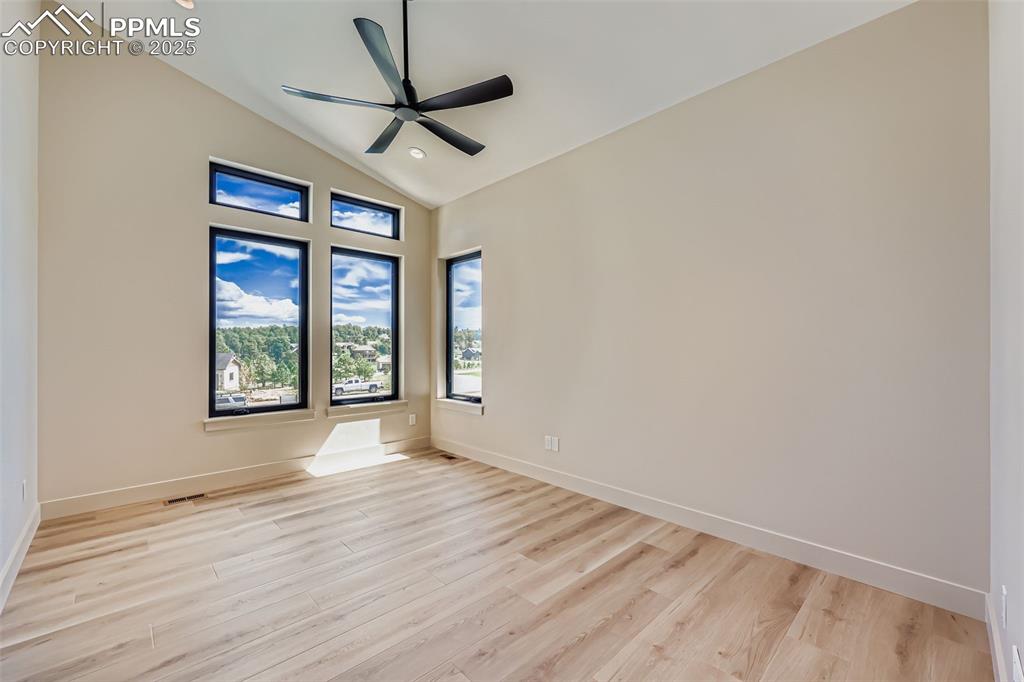 Image 10 of 41: Unfurnished room featuring light wood-style flooring, a ceiling fan, recess