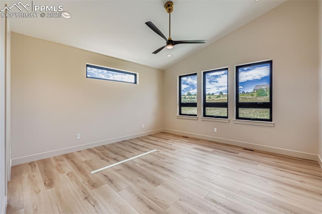 Image 12 of 41: Empty room with lofted ceiling, recessed lighting, light wood-type flooring