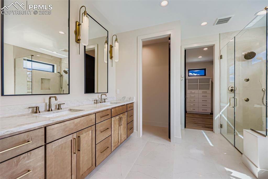 Image 14 of 41: Bathroom featuring a stall shower, double vanity, and recessed lighting