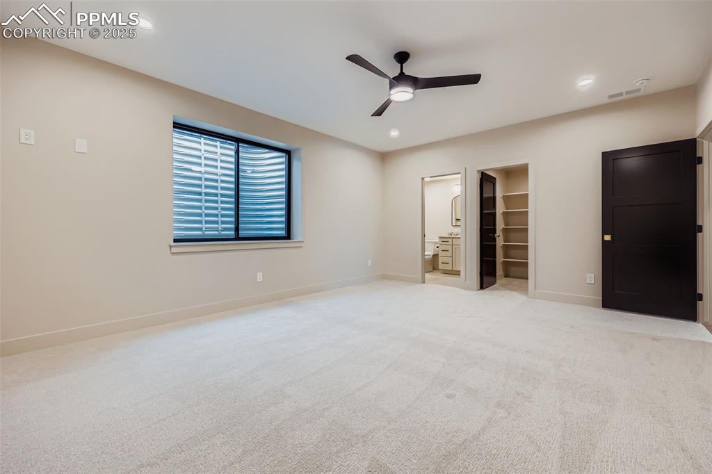 Image 16 of 41: Unfurnished bedroom with a walk in closet, light colored carpet, a ceiling