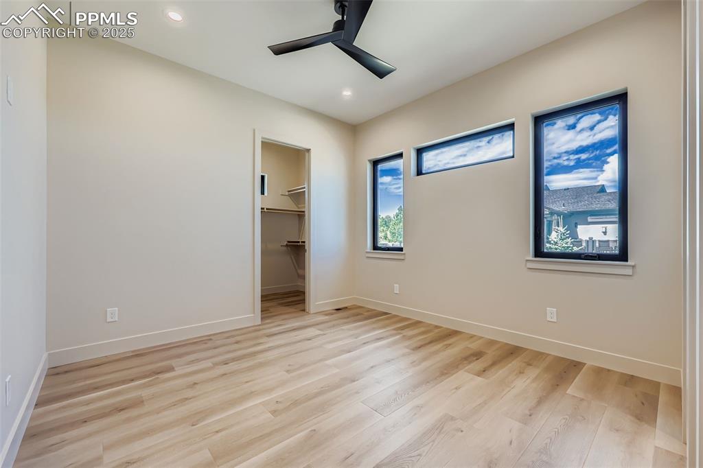 Image 17 of 41: Unfurnished bedroom featuring a spacious closet, light wood-style flooring,