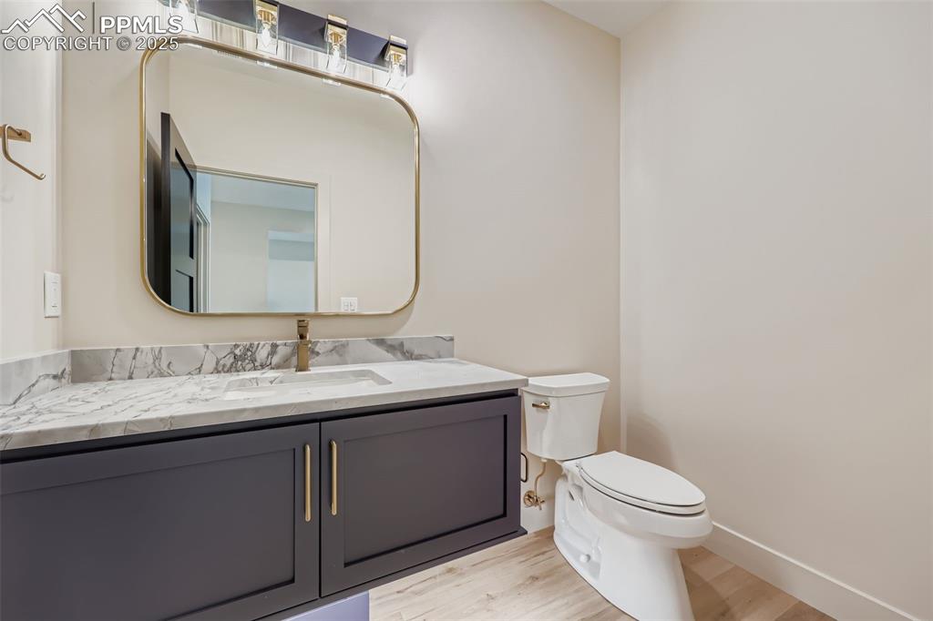Image 20 of 41: Half bathroom featuring vanity and light wood-type flooring