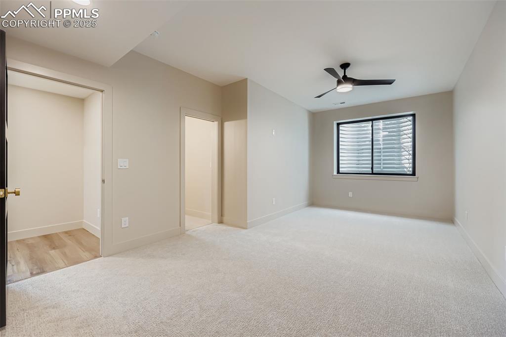 Image 22 of 41: Unfurnished bedroom featuring light colored carpet and a ceiling fan