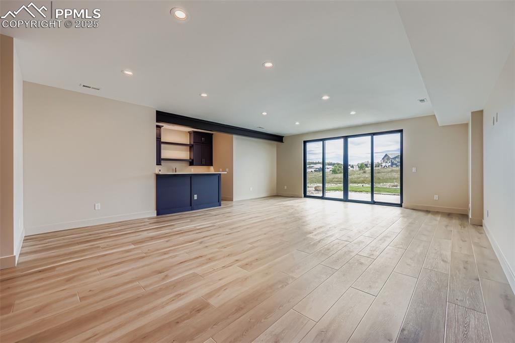 Image 23 of 41: Unfurnished living room with recessed lighting and light wood-style floors