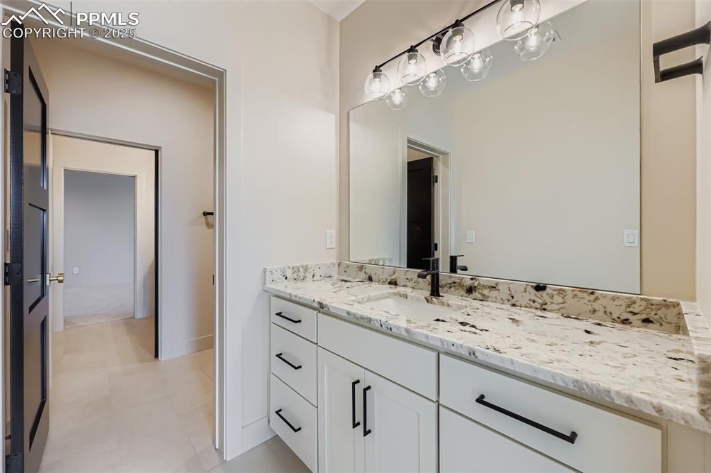 Image 24 of 41: Bathroom featuring vanity and light tile patterned flooring