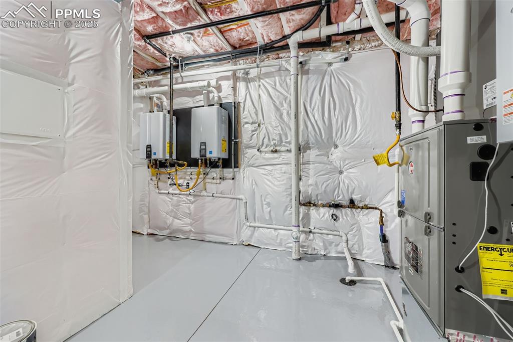 Image 25 of 41: Utilities with heating unit and tankless water heater