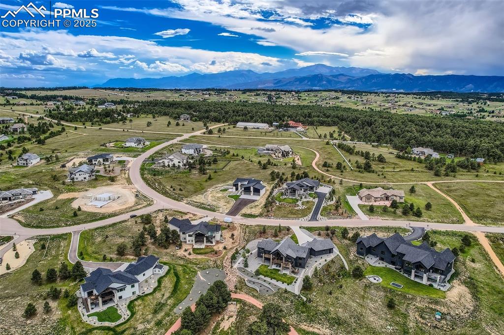 Image 32 of 41: Aerial view of residential area featuring mountains