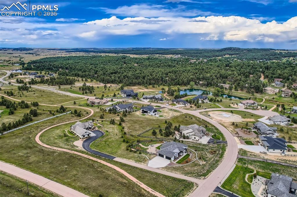 Image 36 of 41: View of property location with nearby suburban area and a large body of wat