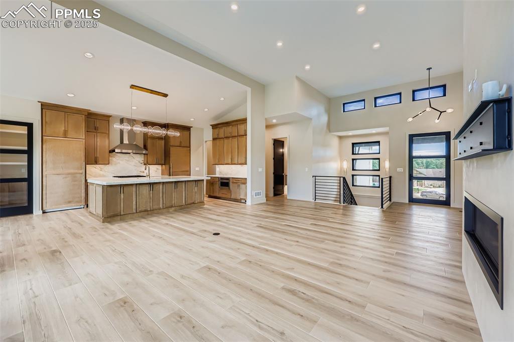 Image 5 of 41: Kitchen featuring open floor plan, decorative light fixtures, a large islan