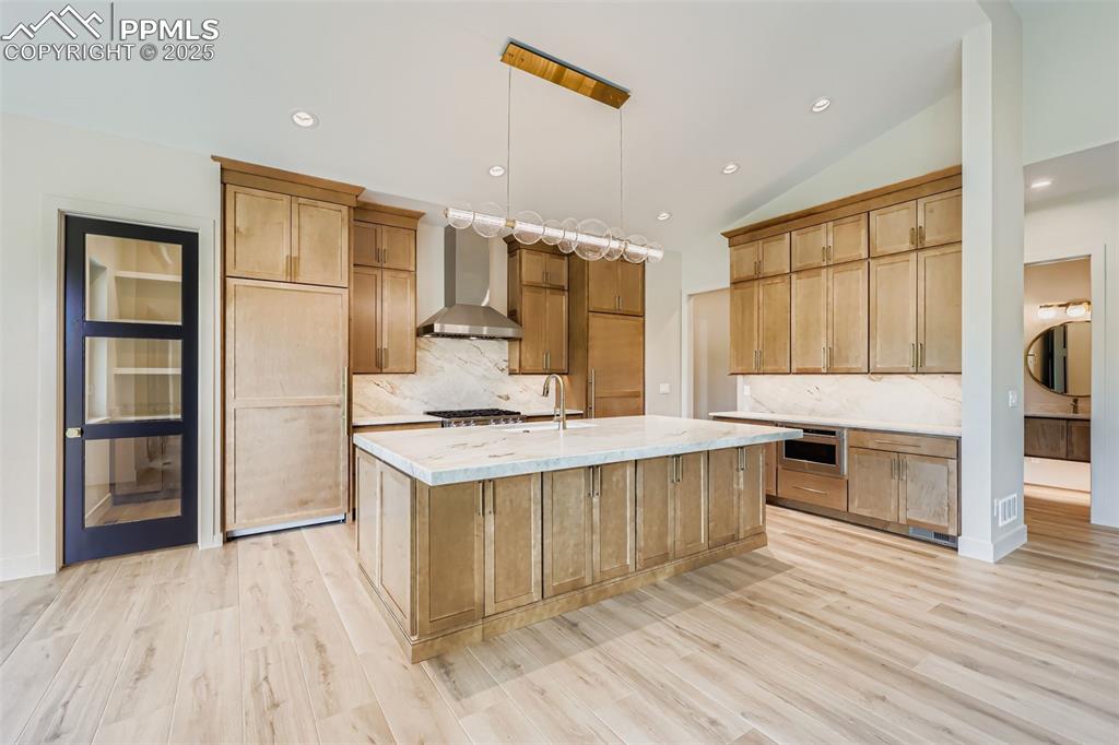 Image 7 of 41: Kitchen featuring tasteful backsplash, recessed lighting, vaulted ceiling,