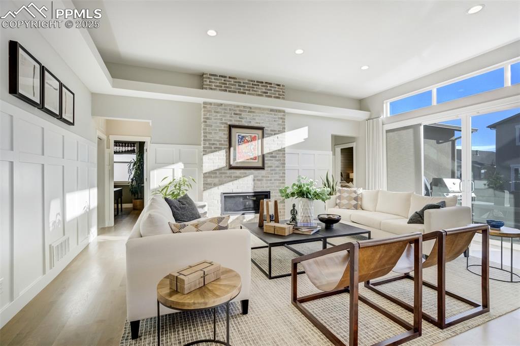 Image 13 of 50: Open Living room features an extended patio door and cozy fireplace