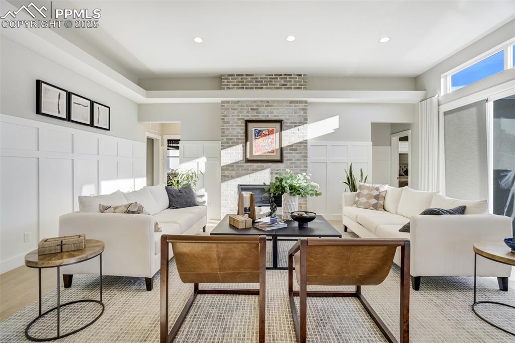 Image 15 of 50: Batten and Board wall treatments and brick fireplace are lovely upgrades!