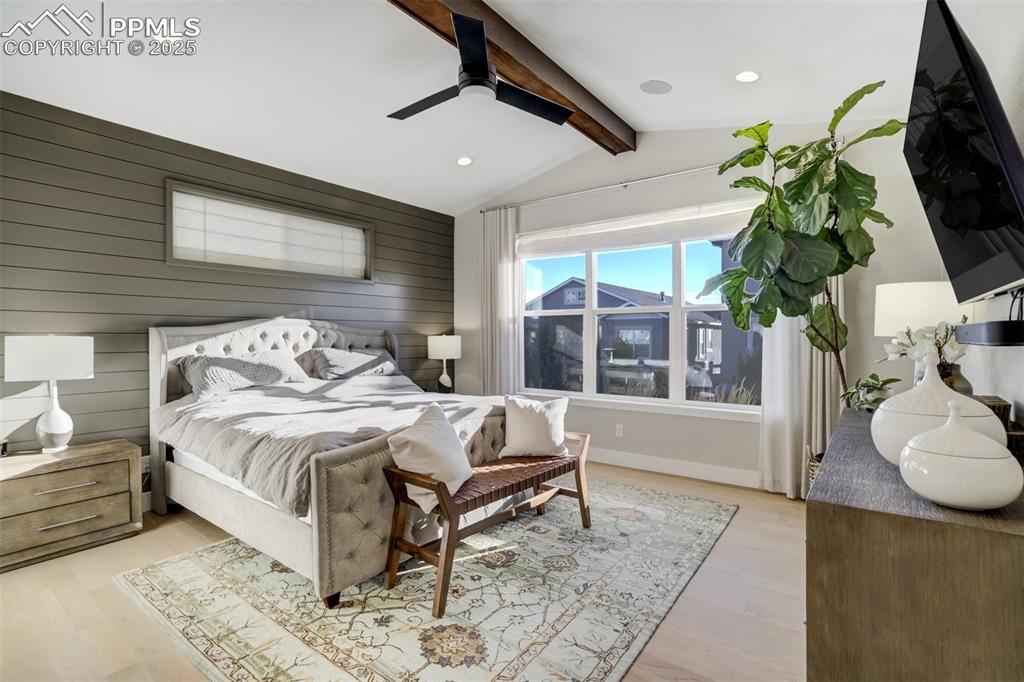 Image 17 of 50: Large Picture window and wood beam in primary suite