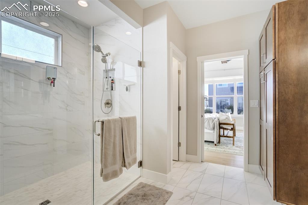 Image 20 of 50: Primary spa shower with dual heads and curbless shower