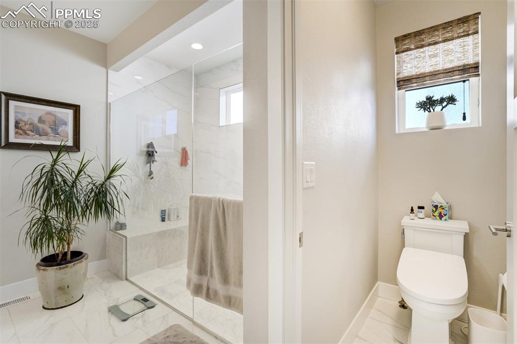 Image 21 of 50: Bench in spa shower and water closet with a door!