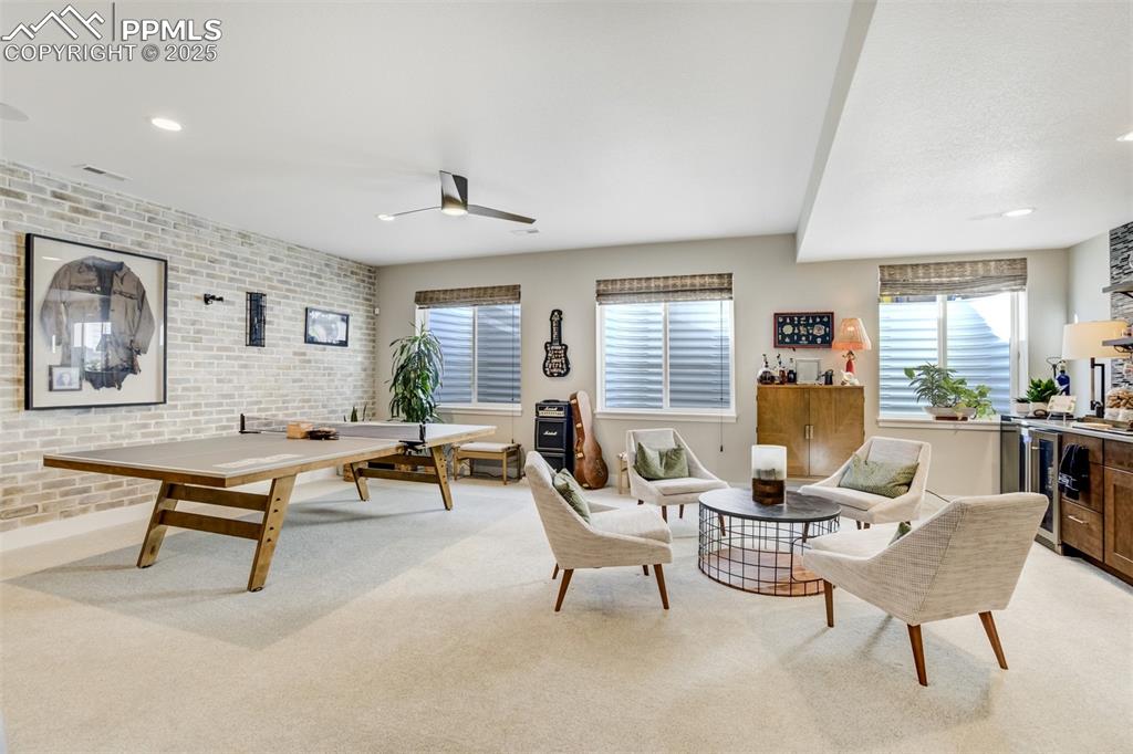 Image 28 of 50: Large rec room in basement with multiple options for use