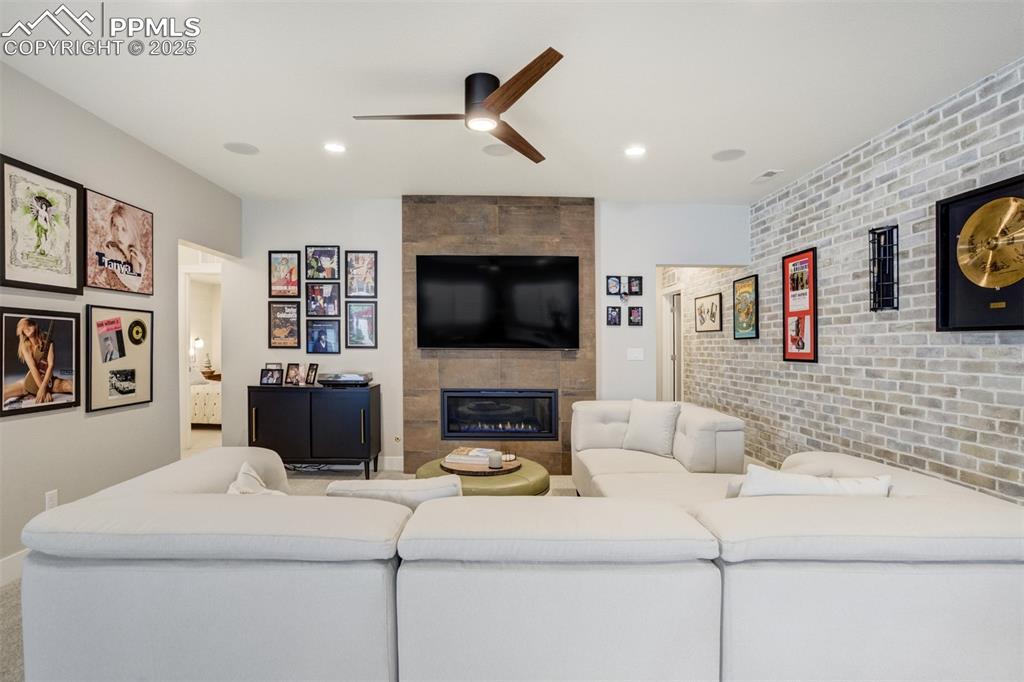 Image 30 of 50: A second gas fireplace in basement along with 5.1 surround sound and home t