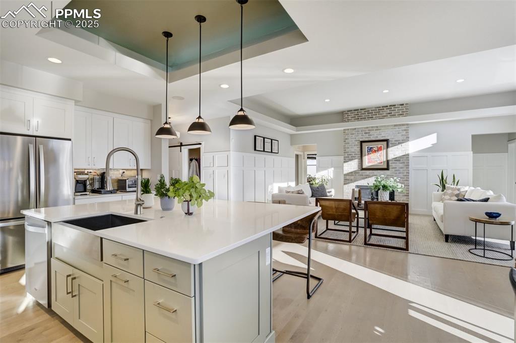 Image 6 of 50: Kitchen opens to family room and all can enjoy the cozy fireplace!