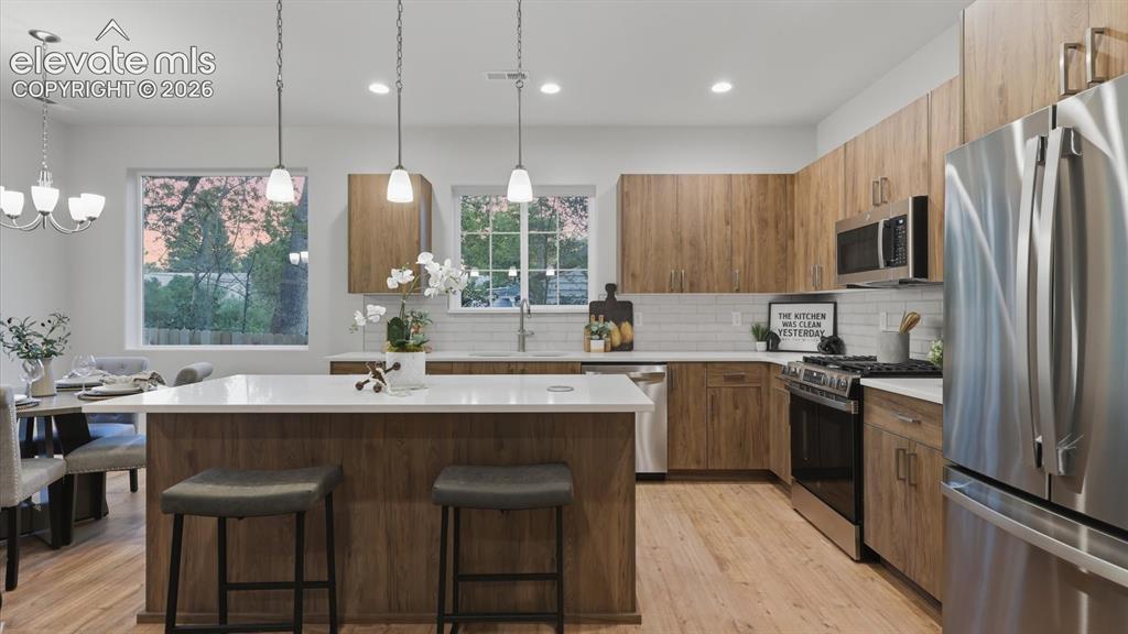 Image 10 of 50: Bright open Living Room with ceiling fan, recessed lighting, LVP flooring,