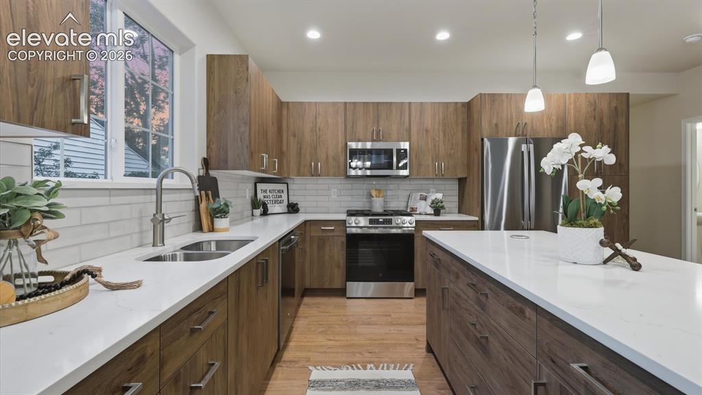 Image 15 of 50: View of the Kitchen and Living Room from the Dining Area.