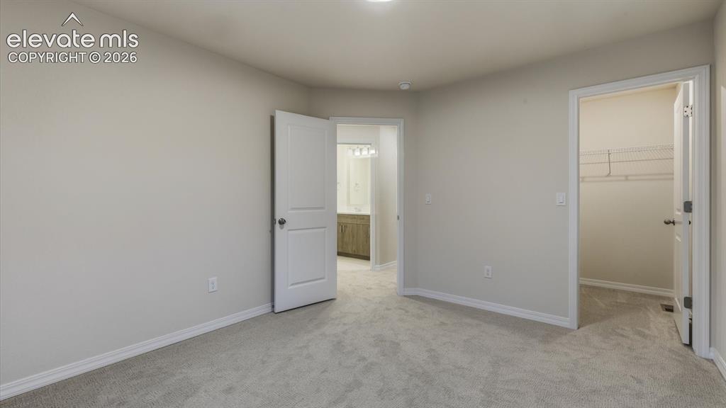 Image 26 of 50: Upper Level Bedroom #2 has neutral carpet.