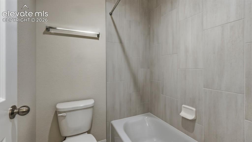 Image 28 of 50: Upper Level Hall Bathroom with dual sink vanity, quartz countertops, mirror