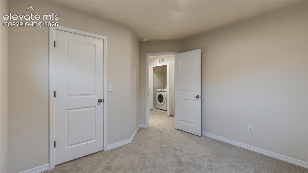 Image 30 of 50: Upper Level Bedroom #3 has neutral carpet.