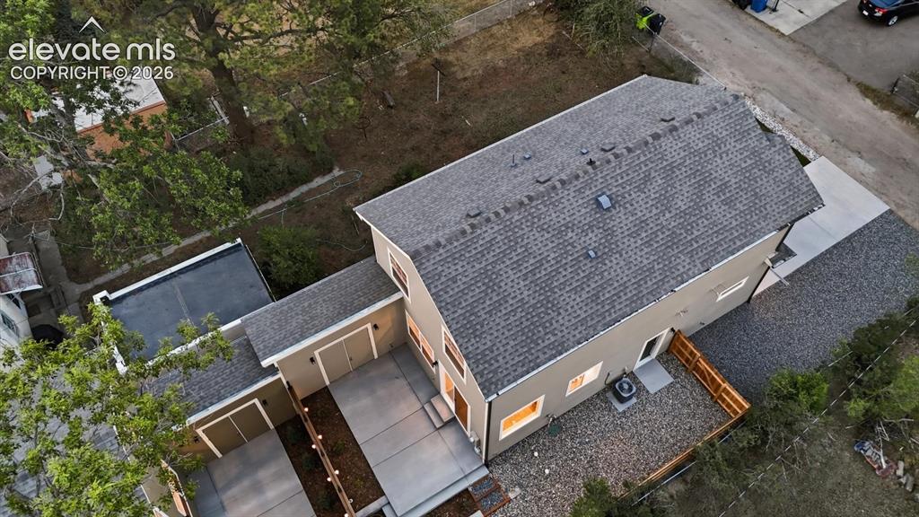 Image 36 of 50: Aerial view of the backyard of Primary home and attached storage wings to a