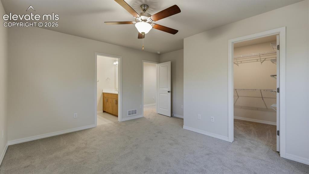 Image 45 of 50: Spacious Living Room in the 2nd property with LVP flooring and ceiling fan.