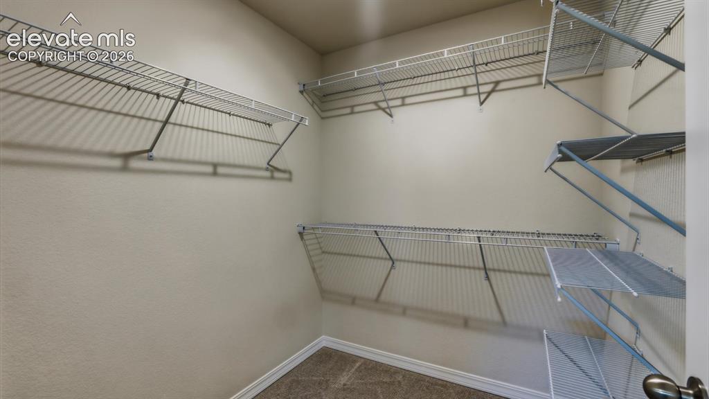 Image 46 of 50: Upper Level Primary Bedroom in the additional living quarters with neutral