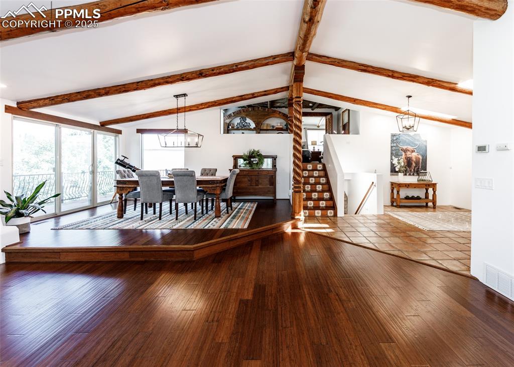 Image 12 of 50: Dining room featuring hardwood / wood-style floors and a chandelier