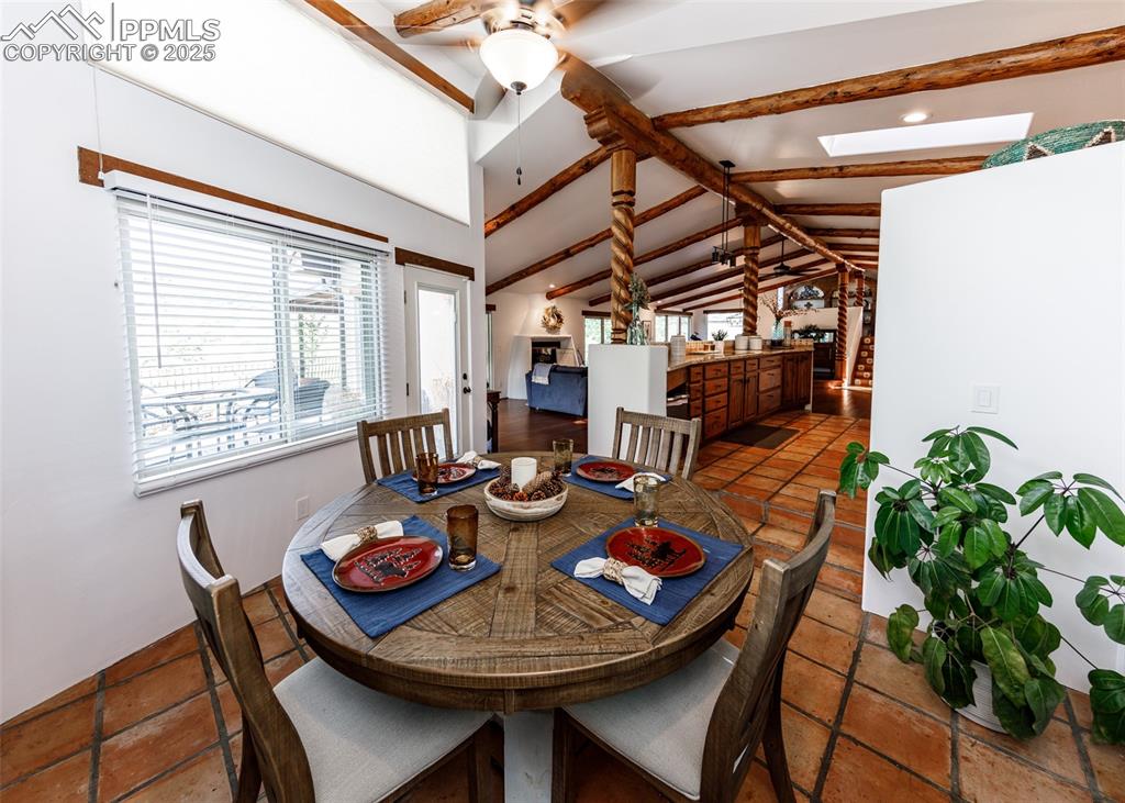 Image 19 of 50: Dining area featuring a ceiling fan and a skylight