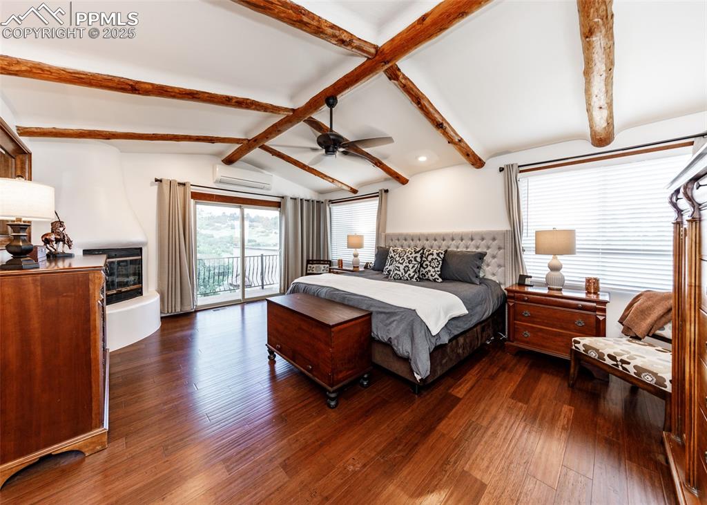 Image 21 of 50: Bedroom featuring access to outside, dark wood-type flooring, a ceiling fan